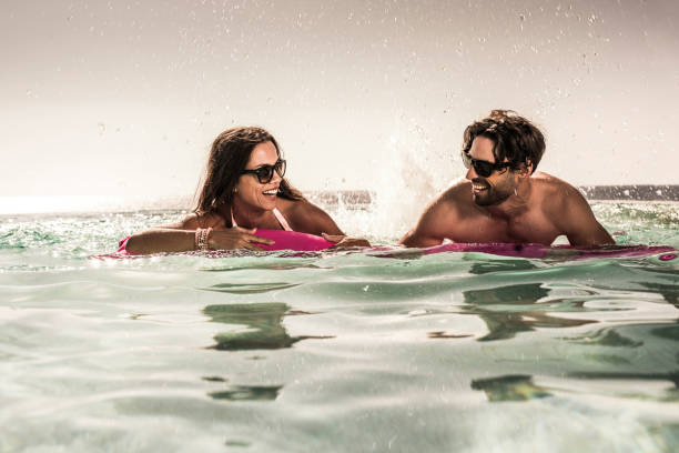 istock Happy couple having fun on pool raft in the pool. 640068970