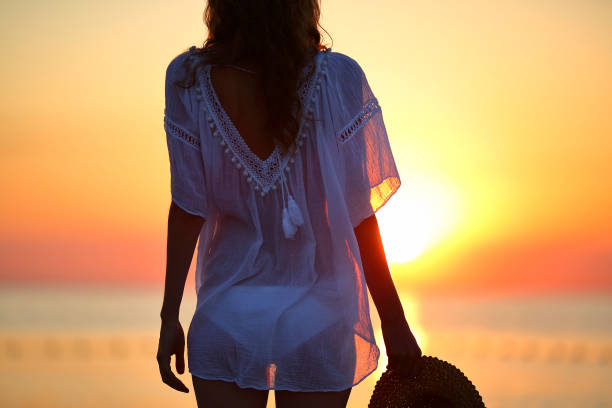 istock Woman on the beach at sunset. Summer vacations concept 640069468