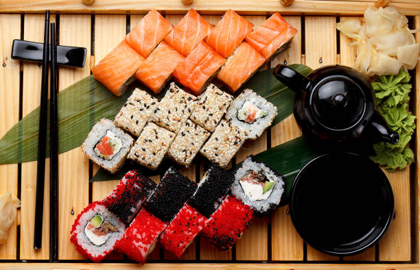 istock Sushi set on a wooden plate and dark concrete background. 640070004