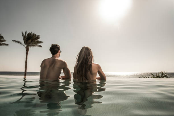 istock Rear view of a couple at the infinity pool. 640070422