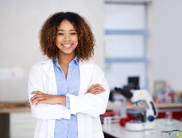 I'll find the cure! Portrait of an attractive young scientist standing with her arms folded in the lab technician stock pictures, royalty-free photos & images