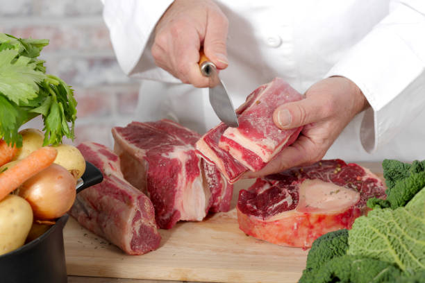 istock Chef cutting the meat on a wooden board 640076858