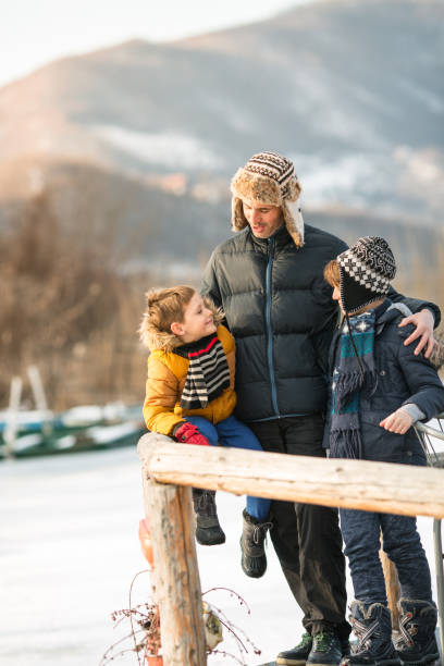 istock Father and sons having winter fun in the lake 640078378