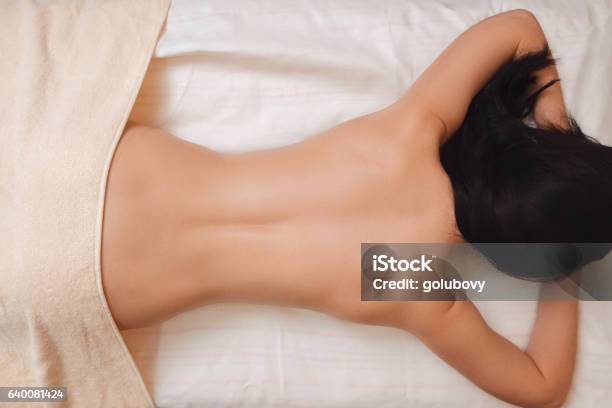 Nude Woman Back On Massage Table Flat Lay Stock Photo - Download Image Now - Back, Massaging, Rear View