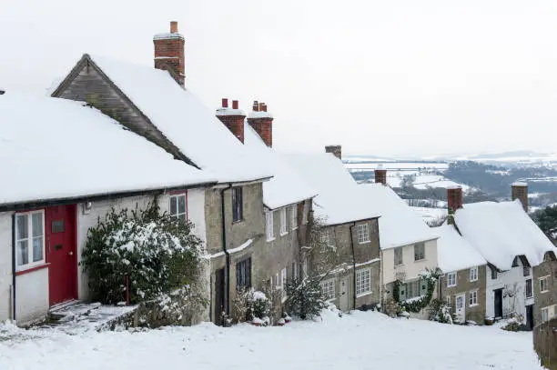 The famous Gold Hill, in Shaftesbury, North Dorset in winter. Location for the making of the Hovis bread advert. Taken in the winter months with covering of snow, cloud cover and good visibility into the distance.