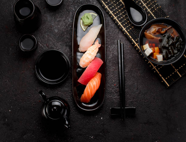 istock Sushi and and miso soup. Dark concrete background 640084026