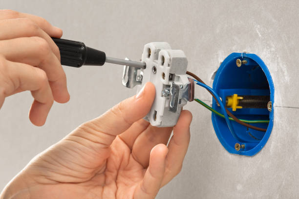 istock hands of electrician with screwdriver installing electrical wall socket 640086856