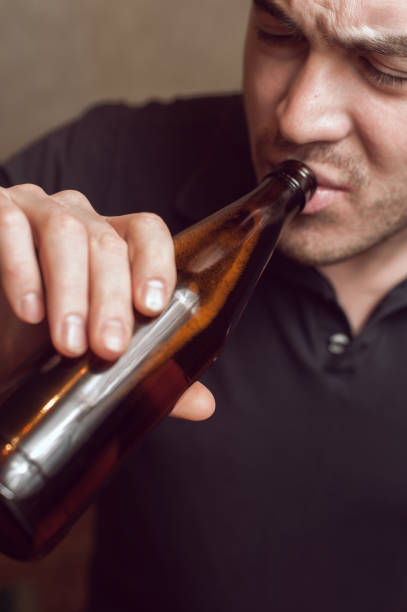 istock Young tired man with beer bottle in hands 640087498