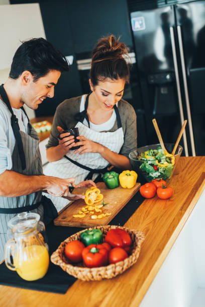 istock Man helping his girlfriend with the cooking 640088348