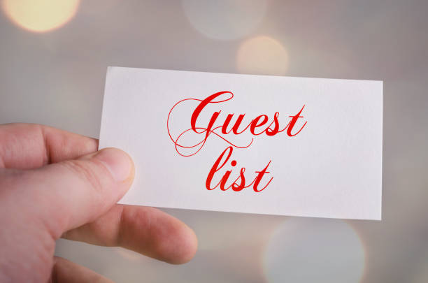 istock Guest list card in hand with bokeh lights background 640088594