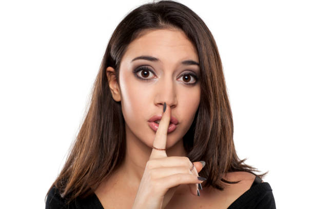 istock girl with a finger in front of her lips 640088972