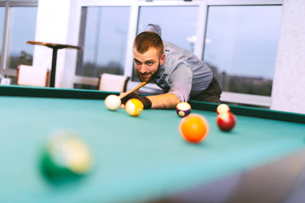 istock Portrait of billiard player aiming during tournament 640089252