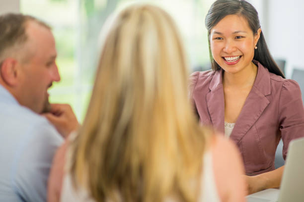 Portrait of cute female executive sitting with her colleagues at a meeting