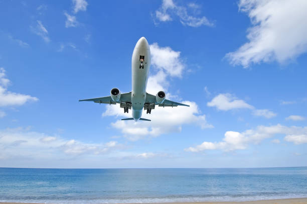 istock airplane landing over the sea 640090828