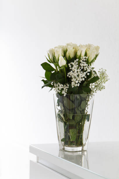 istock Fresh beautiful bunch of white roses in modern vase 640091494