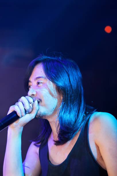 istock Male thai rock singer live on stage 640092536