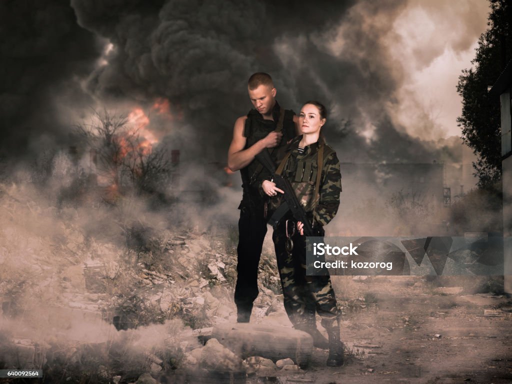 girl and man in military camouflage uniforms among the ruins Stalker - Person Stock Photo