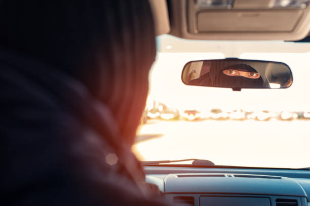 istock Male robber in black mask sitting in stolen car 640093372