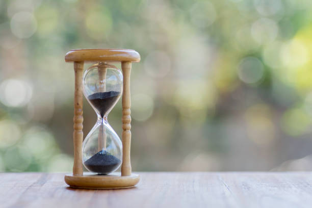 istock Hourglass on wood and background bokeh. 640093966