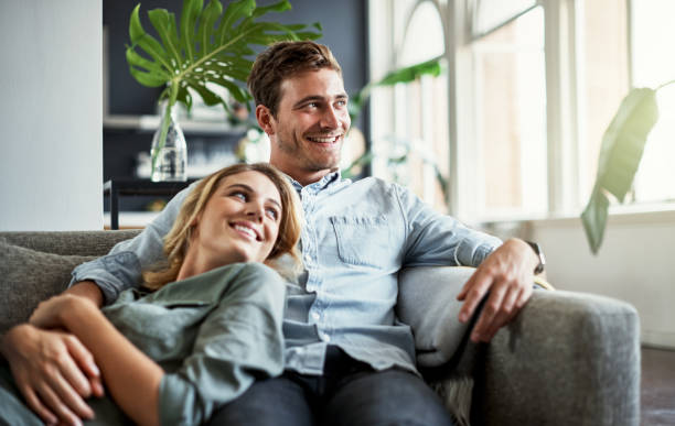 This is what a weekend should look like Cropped shot of an affectionate young couple relaxing at home two people thinking stock pictures, royalty-free photos & images