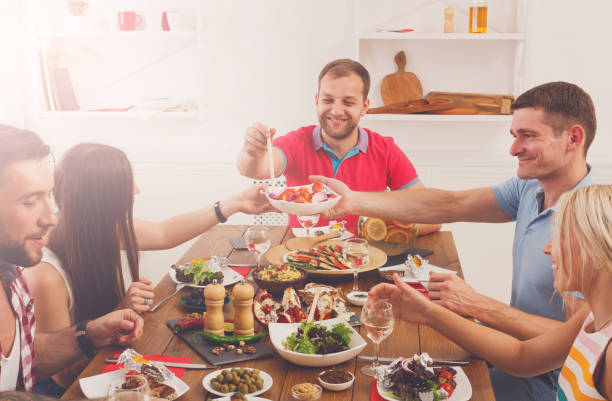 istock People say cheers clink glasses at festive table dinner party 640096660