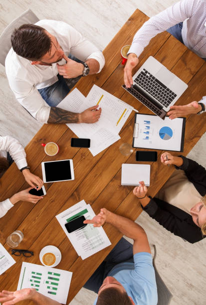 istock Group of busy business people working in office, top view 640097444
