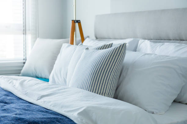 istock Bed maid-up with clean white pillows and bed sheets 640098290