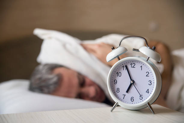 istock Man trying to sleep, when alarm clock ringing 640098574