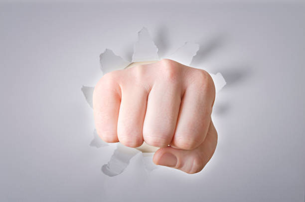 istock Hand break through the white color paper background 640100142