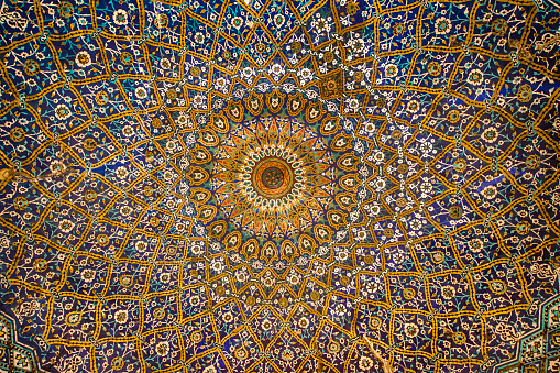 Abstract pattern inside a ceiling dome using the Persian and Islamic architectural style and decoration.