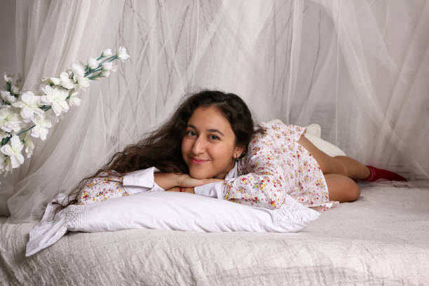 istock Young Gypsy woman lies on a white bed with canopy 640101276