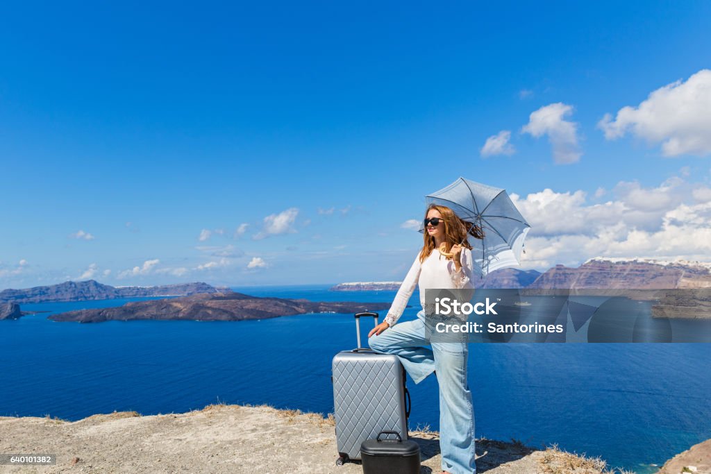 Young woman with suitcase Young woman with suitcase rejoice in the arrival of the sea Adult Stock Photo