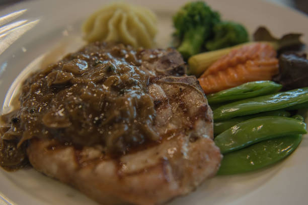 istock Pork steak and vegetable on White plate 640102460