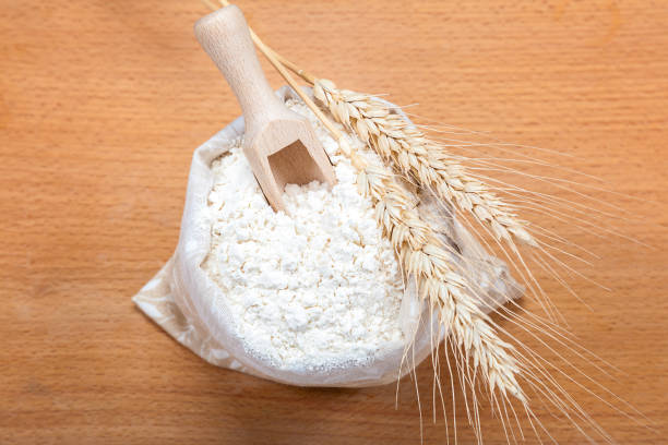 istock Flour in a canvas bag and wheat ears. 640104108