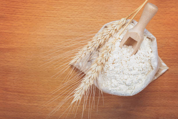 istock Flour in a canvas bag and wheat ears. 640104292