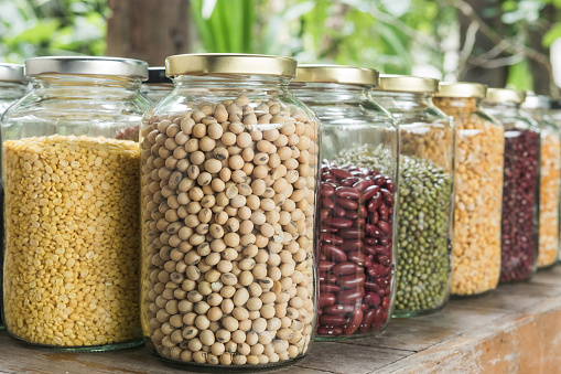 Various dry legumes in a glass jar