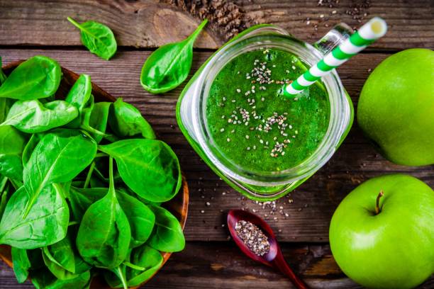istock Green smoothie with spinach, apple, chia seeds on wooden background 640105686