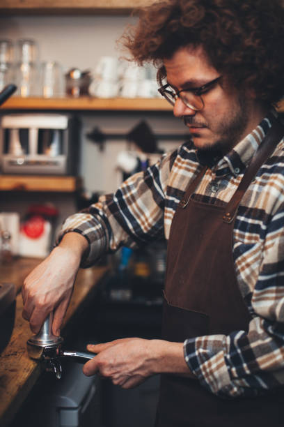 istock Barista tamping fresh coffee 640107234