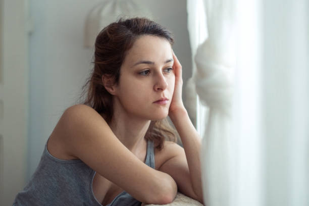 istock Depressed woman sitting at the sofa 640109428
