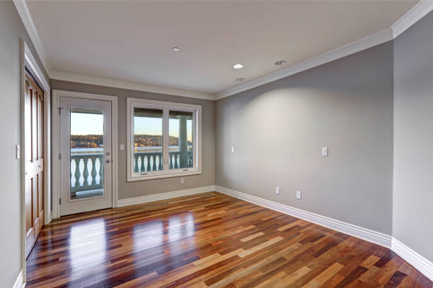 istock Empty room with hardwood floor and door to balcony. 640112204