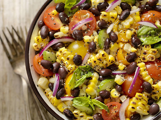 Grilled Corn and Black Bean Salad Grilled Corn and Black Bean Salad with Tomatoes, Red Onions, Cucumber and Basil  -Photographed on Hasselblad H3D2-39mb Camera corn salad stock pictures, royalty-free photos & images