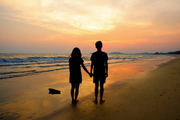 istock Couple holding hand looking sun set at the beach. 640114876