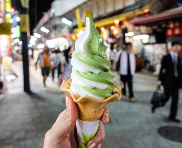 istock Ice cream cone held up in the city 640114928
