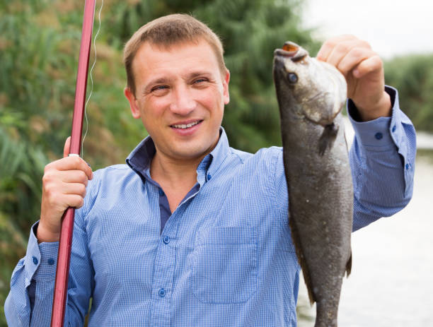 istock Man holding fish after fishing 640115492