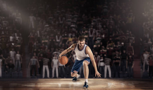 istock basketball player on court with ball in light rays 640115642