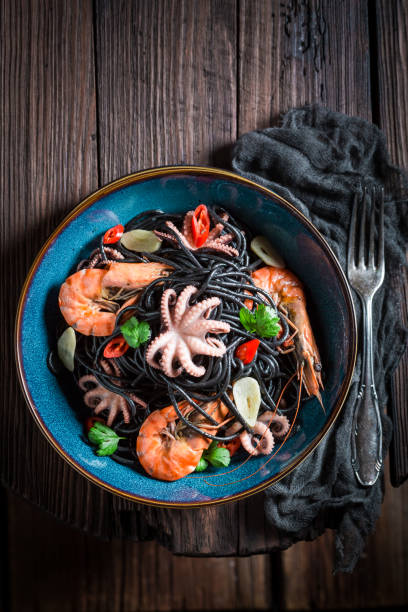 istock Fresh spaghetti with seafood with shrimp, octopus and parsley 640117752