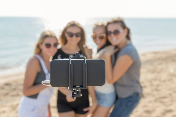 istock Happy women taking pictures with selfie stick 640119848
