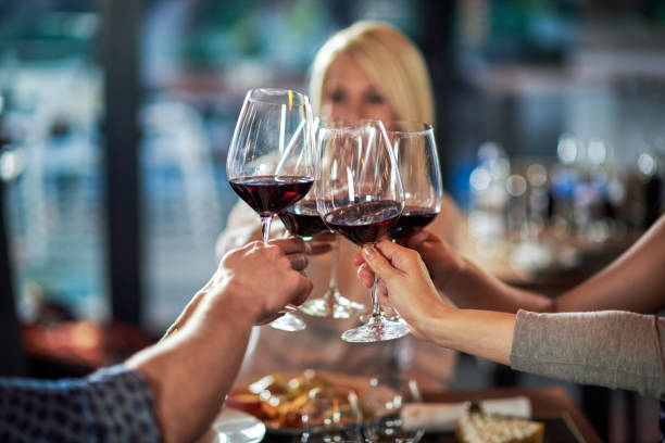 Close up view of wine glasses joined together for a toast.