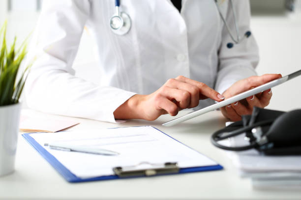 Female doctor hold digital tablet pc Female doctor hold digital tablet pc and point in touch screen with finger closeup. Human interaction, professional consultation, therapeutist examine test results, new search opportunities concept medical insurance data stock pictures, royalty-free photos & images