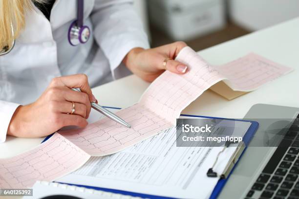 Doctor Hands With Cardiogram Chart On Clipboard Pad Stock Photo - Download Image Now